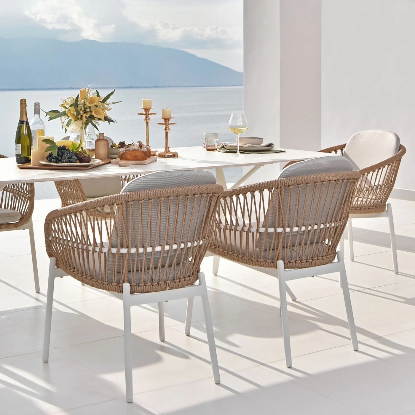 Complete outdoor dining set on a balcony over looking the water.