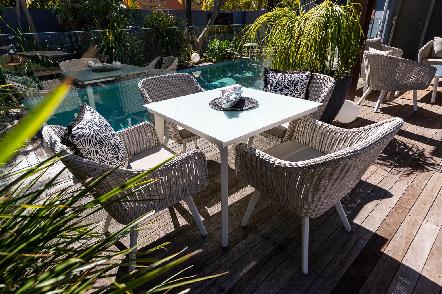 A complete outdoor dining set, by the pool.