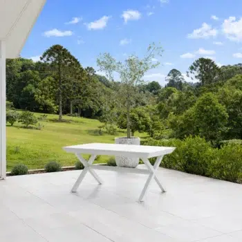 Tropea Extension Small Outdoor Table with powder-coated aluminium frame and slatted tabletop, available in White and Charcoal, styled for modern outdoor entertaining.