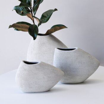 Ceramic hand potted Shard vase white collection displayed on a table for interior styling.