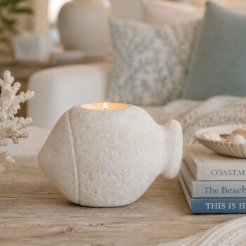 Cement Fish Tea Light Holder in White styled on a wooden coffee table with coastal decor and books