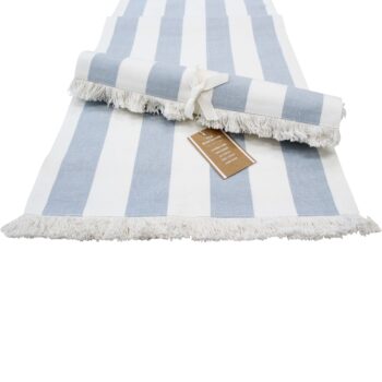 Chambray Stripe Cotton Table Runner Blue Stripe rolled out on a white surface
