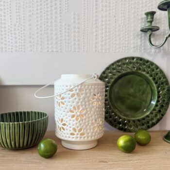 Metal Washball Lantern in White and Green displayed on a wooden surface with home decor