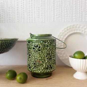 Metal Washball Lantern in White and Green displayed on a wooden surface with home decor