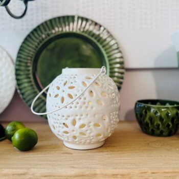 Metal Washball Lantern in White and Green displayed on a wooden surface with home decor