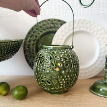 Metal Washball Lantern in White and Green displayed on a wooden surface with home decor