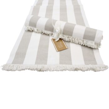 Chambray Stripe Cotton Table Runner Natural Stripe rolled out on a white surface